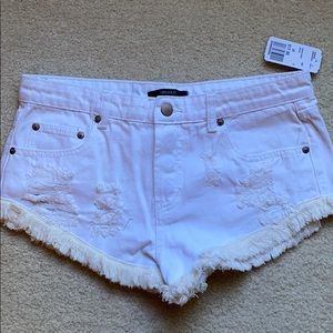 White ripped jean shorts